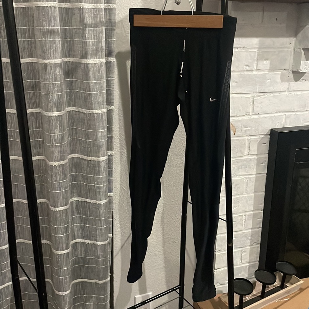 Black Nike dri-fit nike running. Size xs . Zipper detailing by the ankle .